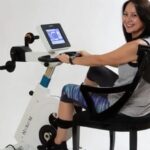 Patient in recovery using active-passive ergometer cycle