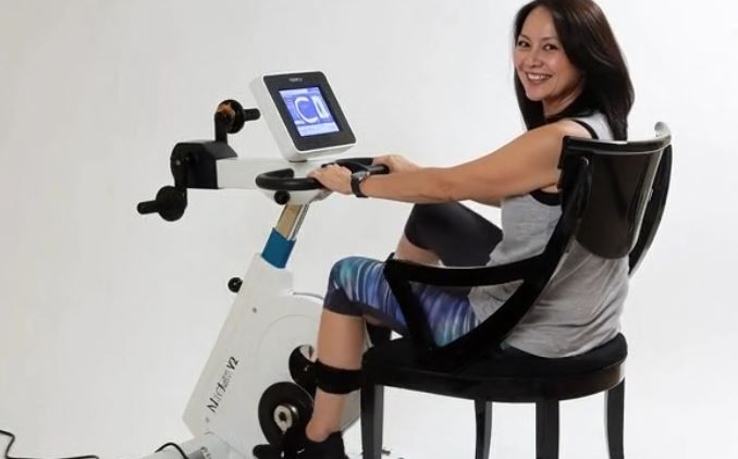 Patient in recovery using active-passive ergometer cycle
