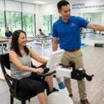 Clinic Rehab therapist with recovering patient